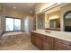 Bright bathroom featuring a soaking tub with tile surround and a glass block shower at 2813 W Hiddenview Dr, Phoenix, AZ 85045