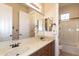 Bathroom featuring a double vanity, large mirror, and a bathtub/shower combo at 2813 W Hiddenview Dr, Phoenix, AZ 85045