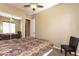 Bedroom with a mirrored closet door, chair, ceiling fan, and neutral colored carpet at 2813 W Hiddenview Dr, Phoenix, AZ 85045