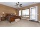 Comfortable bedroom with neutral walls, and bright windows, featuring a ceiling fan and carpet at 2813 W Hiddenview Dr, Phoenix, AZ 85045