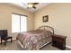 Cozy bedroom featuring a ceiling fan, Southwestern-style bedding, and neutral carpeting at 2813 W Hiddenview Dr, Phoenix, AZ 85045