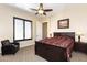 Relaxing bedroom with a ceiling fan, natural light, and comfortable seating at 2813 W Hiddenview Dr, Phoenix, AZ 85045