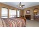 Comfortable bedroom with neutral walls, and bright windows, featuring a ceiling fan and carpet at 2813 W Hiddenview Dr, Phoenix, AZ 85045