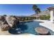 A backyard pool has a rock waterfall feature and integrated table at 2813 W Hiddenview Dr, Phoenix, AZ 85045