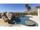 Luxury pool features a rock waterfall, and swim-up bar, set against a scenic mountain backdrop at 2813 W Hiddenview Dr, Phoenix, AZ 85045