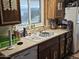 Functional kitchen featuring wood cabinetry, a window over the sink, and essential appliances for cooking at 3160 E Main St # 62, Mesa, AZ 85213