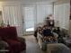 Bright and airy living room with comfortable armchairs, a door to the outside, and lots of natural light at 3160 E Main St # 62, Mesa, AZ 85213