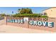 Charming community signage at Village Grove 55+ Park, welcoming residents and visitors at 3160 E Main St # 62, Mesa, AZ 85213