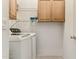 Functional laundry area with washer, dryer, wooden cabinets and wire rack shelving at 4308 E Smokehouse Trl, Cave Creek, AZ 85331