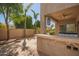 An inviting backyard with a built-in grill, a fan, a fire pit, and tasteful landscaping at 4617 S Carmine --, Mesa, AZ 85212