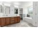 The bathroom features wood cabinets with double sinks, a soaking tub, and modern fixtures at 4617 S Carmine --, Mesa, AZ 85212