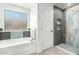 Bright bathroom featuring a soaking tub, tiled shower with built in shelving, and neutral color palette at 4617 S Carmine --, Mesa, AZ 85212