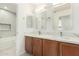 Double sink bathroom vanity with a white marble countertop and wooden cabinets at 4617 S Carmine --, Mesa, AZ 85212