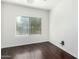 Sunlit bedroom with wood floors, a neutral color palette, and a large window at 4617 S Carmine --, Mesa, AZ 85212