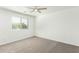 Bedroom with plush carpet, a ceiling fan and a large window providing natural light at 4617 S Carmine --, Mesa, AZ 85212