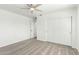 Bedroom featuring plush carpet, a modern ceiling fan, closet with sliding doors, and two entry doors at 4617 S Carmine --, Mesa, AZ 85212