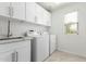 A practical laundry room featuring a sink, countertop, washer, dryer, and ample storage at 4617 S Carmine --, Mesa, AZ 85212