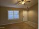 Inviting living room with hardwood floors, plantation shutters, a ceiling fan, and neutral paint at 4816 E Corral Rd # 2, Phoenix, AZ 85044