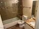 Relaxing bathroom features a tub, glass-enclosed shower, and neutral color scheme at 5132 N 31St Way # 127, Phoenix, AZ 85016