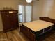 Cozy bedroom boasts natural light, and a classic wooden dresser and matching furniture at 5132 N 31St Way # 127, Phoenix, AZ 85016