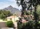 Scenic home exterior boasts mountain views, a red tile roof and is surrounded by lush landscaping at 5132 N 31St Way # 127, Phoenix, AZ 85016