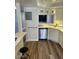 Well-lit kitchen with stainless steel dishwasher and barstool seating area open to dining area at 5132 N 31St Way # 127, Phoenix, AZ 85016