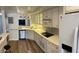 Modern kitchen featuring stainless steel appliances, mosaic tile backsplash, and a convenient pass-through at 5132 N 31St Way # 127, Phoenix, AZ 85016