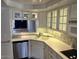 Bright kitchen area featuring white cabinetry, stainless steel appliances, and tile backsplash at 5132 N 31St Way # 127, Phoenix, AZ 85016