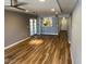 Spacious living room with wood floors, light grey walls, and a ceiling fan at 5132 N 31St Way # 127, Phoenix, AZ 85016
