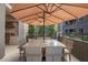 A covered patio with a large umbrella that provides ample shade for a large table and seating for eight at 5250 E Deer Valley Dr # 146, Phoenix, AZ 85054