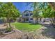 Large backyard with vibrant greenery, decorative landscaping, and an inviting outdoor space at 5618 W Blackhawk Dr, Glendale, AZ 85308