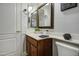 Charming bathroom with a wood vanity, decorative mirrors, and a clean, well-maintained space at 5618 W Blackhawk Dr, Glendale, AZ 85308