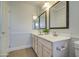 Spacious bathroom boasts a double vanity with decorative mirrors, ample lighting, and tile flooring at 5618 W Blackhawk Dr, Glendale, AZ 85308