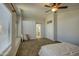 Bright bedroom featuring a ceiling fan, carpet flooring, and ensuite bathroom access at 5618 W Blackhawk Dr, Glendale, AZ 85308