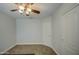 This is a simplistic bedroom with carpet and a ceiling fan at 5618 W Blackhawk Dr, Glendale, AZ 85308