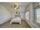 Well-lit bedroom with carpet floors, a ceiling fan, and a comfortable bed setup at 5618 W Blackhawk Dr, Glendale, AZ 85308