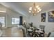 Dining area with chandelier and open to living room with couch and stairs in the background at 5618 W Blackhawk Dr, Glendale, AZ 85308