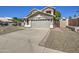 Traditional home with a spacious driveway and a two-car garage, blending functionality and style for everyday living at 5618 W Blackhawk Dr, Glendale, AZ 85308