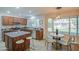 Well-lit kitchen with wood cabinets, granite countertops, island with seating, and eat-in dining at 5618 W Blackhawk Dr, Glendale, AZ 85308