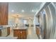 Kitchen with stainless steel appliances that opens to a living room with a blue couch at 5618 W Blackhawk Dr, Glendale, AZ 85308