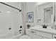 Bathroom featuring tub with shower, single sink, modern fixtures, and white cabinets at 5812 E Sanford St, Mesa, AZ 85215