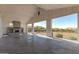 Spacious bonus room featuring a fireplace and seamless access to the backyard and pergola at 5812 E Sanford St, Mesa, AZ 85215