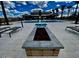 Outdoor fire pit surrounded by desert landscape and pool view, ideal for relaxation and social gatherings at 5812 E Sanford St, Mesa, AZ 85215