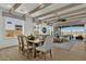 Open-concept living and dining area featuring exposed ceiling beams at 5812 E Sanford St, Mesa, AZ 85215