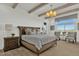 Serene bedroom with large windows, neutral tones, and wood-look flooring at 5812 E Sanford St, Mesa, AZ 85215