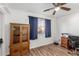 Bright bedroom with wood-look floors, large window, and ample space for a home office setup at 624 E Laguna Dr, Tempe, AZ 85282