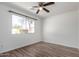 Well-lit bedroom with wood-look flooring, a window, and neutral walls at 624 E Laguna Dr, Tempe, AZ 85282