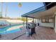 Relaxing covered patio with a grill overlooking the sparkling pool, perfect for outdoor dining and entertaining at 624 E Laguna Dr, Tempe, AZ 85282