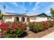 Charming single-story home with solar panels, lush landscaping, and a welcoming arched entryway at 624 E Laguna Dr, Tempe, AZ 85282