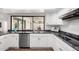 Bright kitchen with stainless steel appliances, a large window with a pool view, and ample counter space at 624 E Laguna Dr, Tempe, AZ 85282